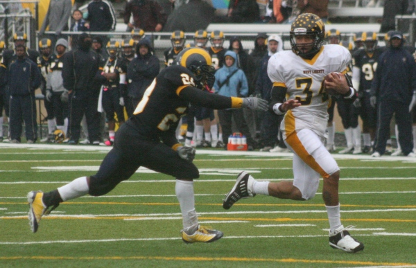 West Liberty tailback Kevon Calhoun (34) outraces Shepherd defensive back Deante Steele (28) to the end zone on a 25-yard scoring run during the third quarter of Saturday's West Virginia Conference game at Ram Stadium in Shepherdstown, W.Va.
