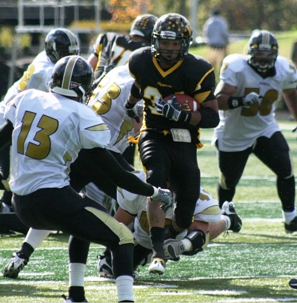 West Liberty tailback Kevon Calhoun (34) weaves his way through traffic for a first down during Saturday’s 52-30 victory against West Virginia State. Calhoun rushed for 157 yards and 2 touchdowns on just 14 carries as the Hilltoppers took over the national scoring lead. 